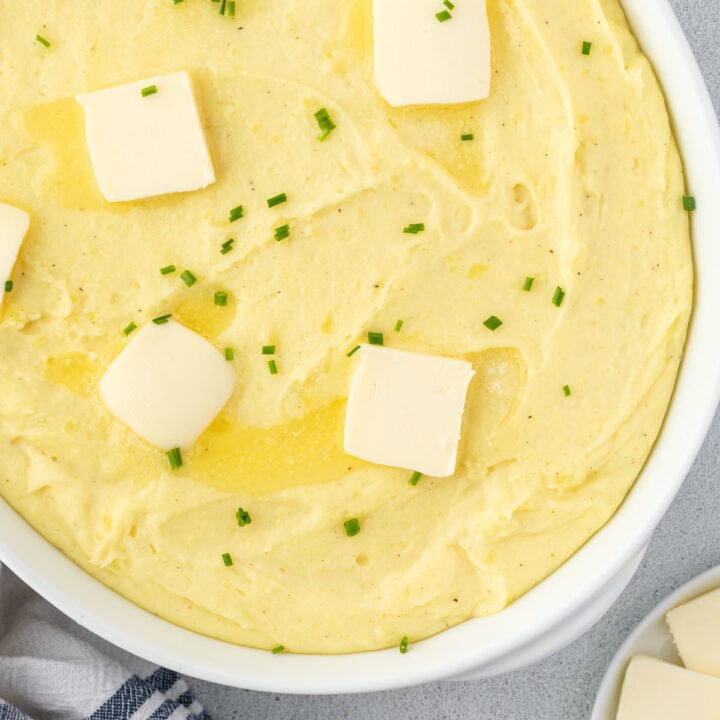 A velvety mashed potatoes recipe in a white oval baking dish.