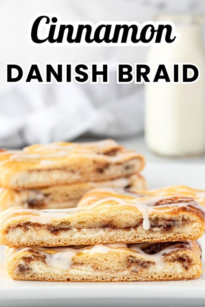 Slices of cinnamon Danish braid are stacked with icing drizzled on top, while a bottle of milk sits in the background.