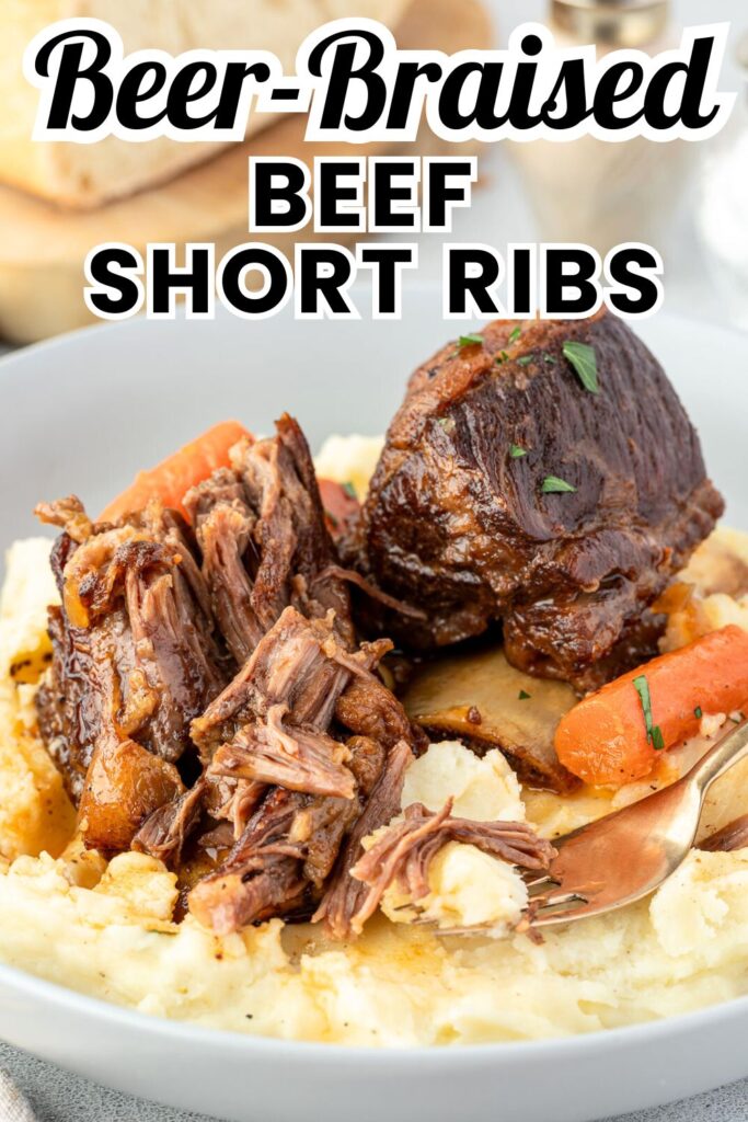 A plate of tender beer-braised short ribs, served with carrots on creamy mashed potatoes.