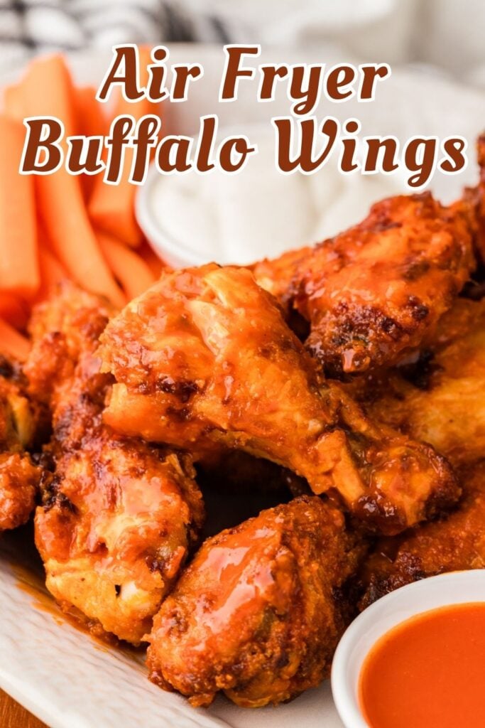Plate of buffalo wings with buffalo sauce, carrot sticks, and a cup of dip, labeled "Air Fryer Buffalo Wings.