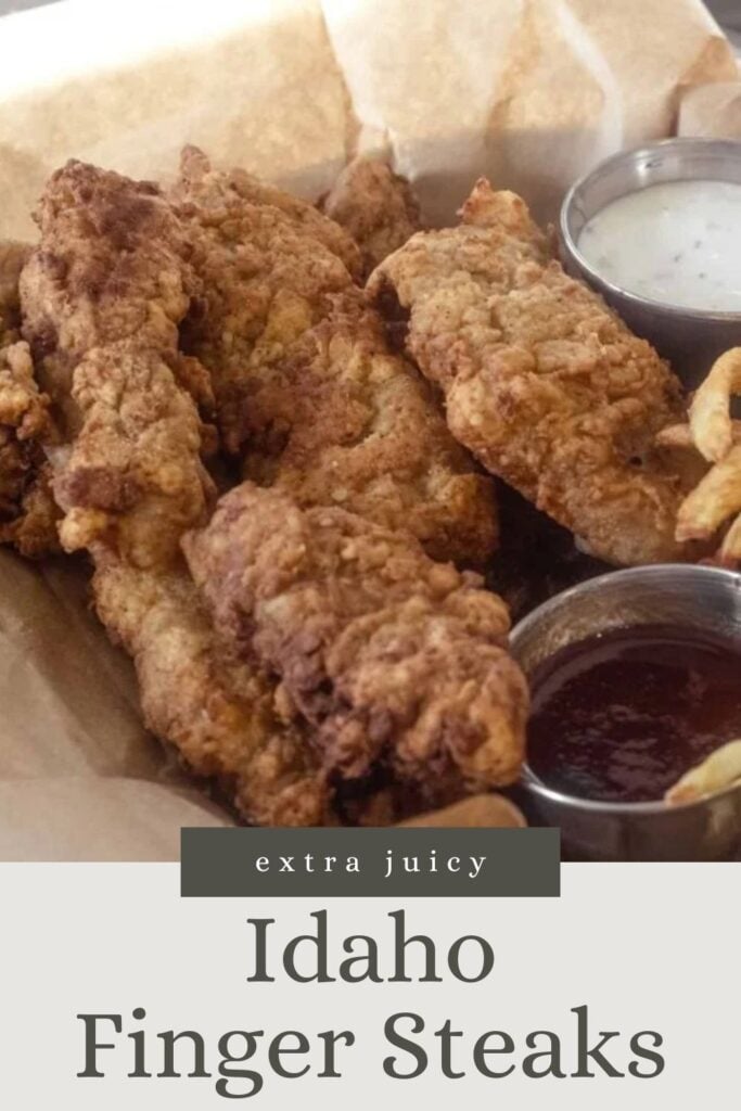 Crispy fried finger steaks with dipping sauces and curly fries on parchment paper. Text reads: Idaho Finger Steaks.