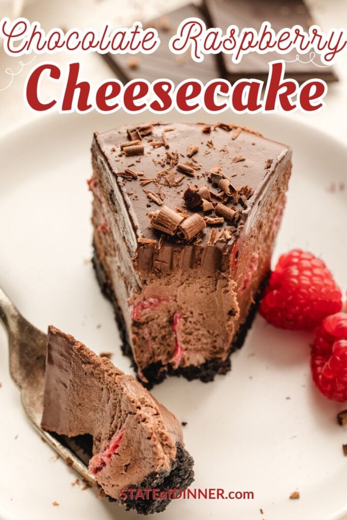 A slice of chocolate raspberry cheesecake with chocolate shavings and fresh raspberries on a white plate.