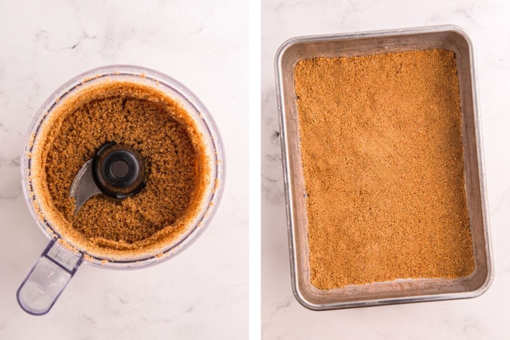 Crushed graham crackers in a food processor and pressed into a baking pan on a marble surface.