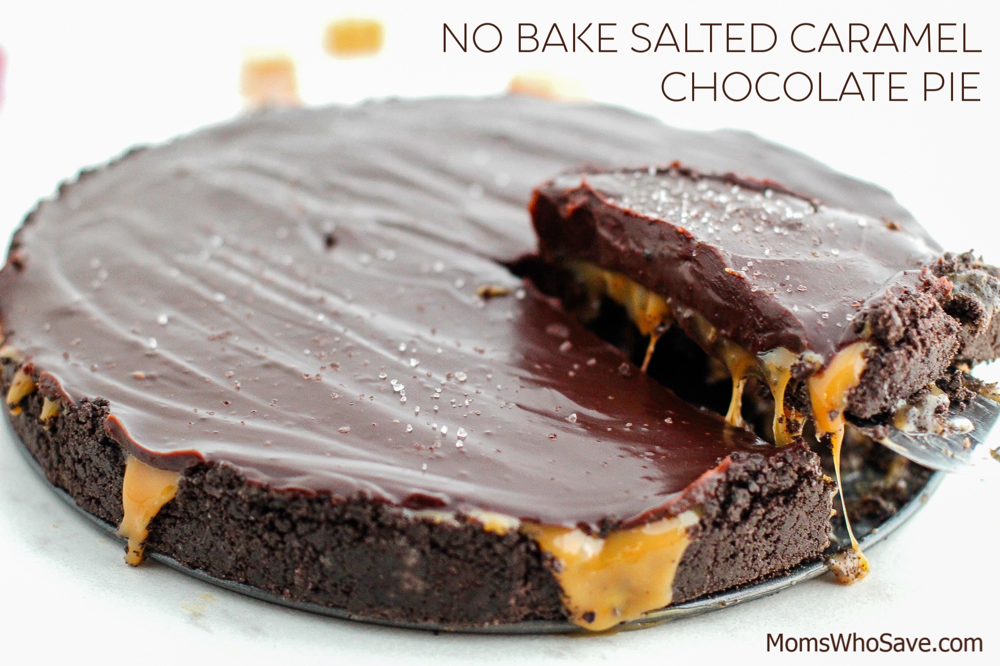 A no-bake salted caramel chocolate pie with a slice being served, caramel oozing from the crust.