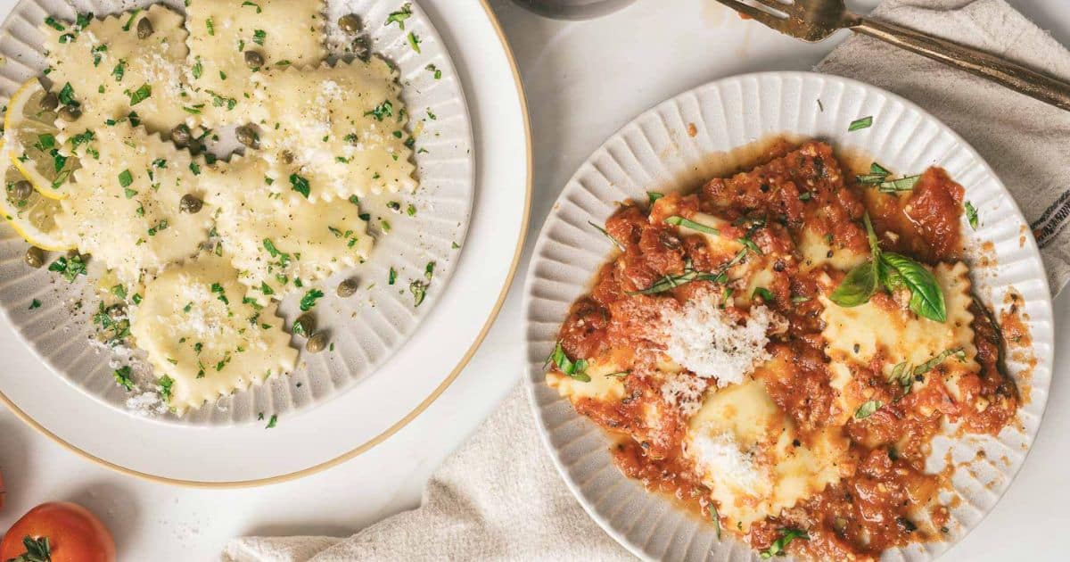 Two plates of ravioli: one with white sauce and capers, the other with tomato sauce and grated cheese.