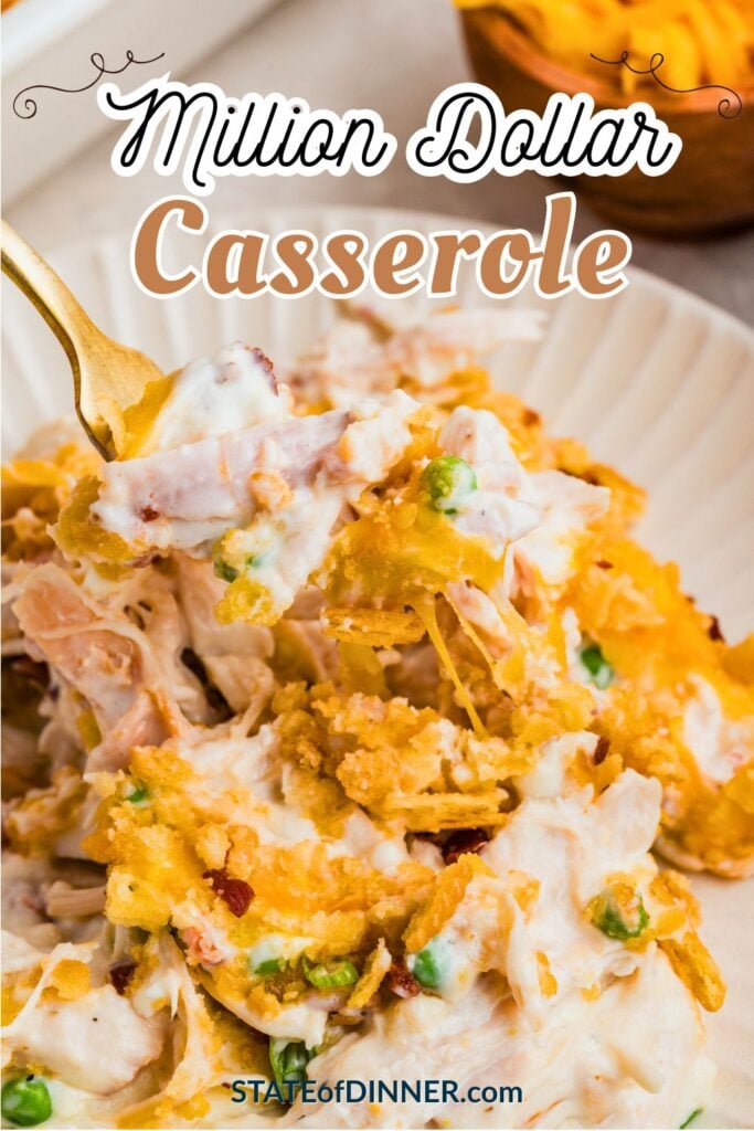 Creamy chicken casserole with cheese, peas, and crunchy topping on white plate, fork lifting a bite.