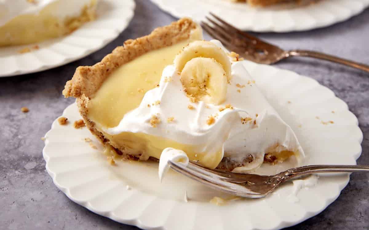 A close up shot of banana cream pie with walnut crust.