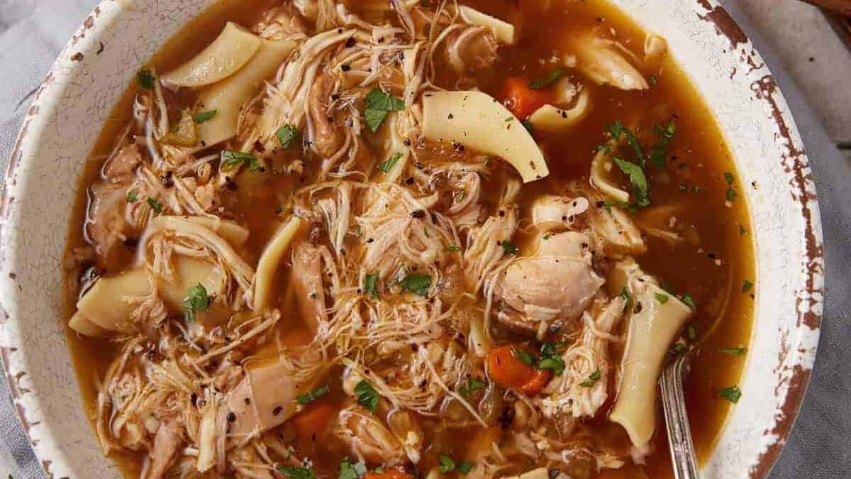 A close up shot of chicken noodle soup.