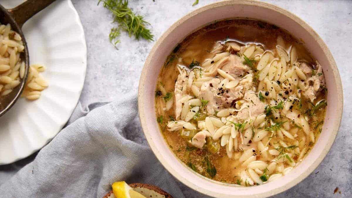 A close up shot of chicken orzo soup.