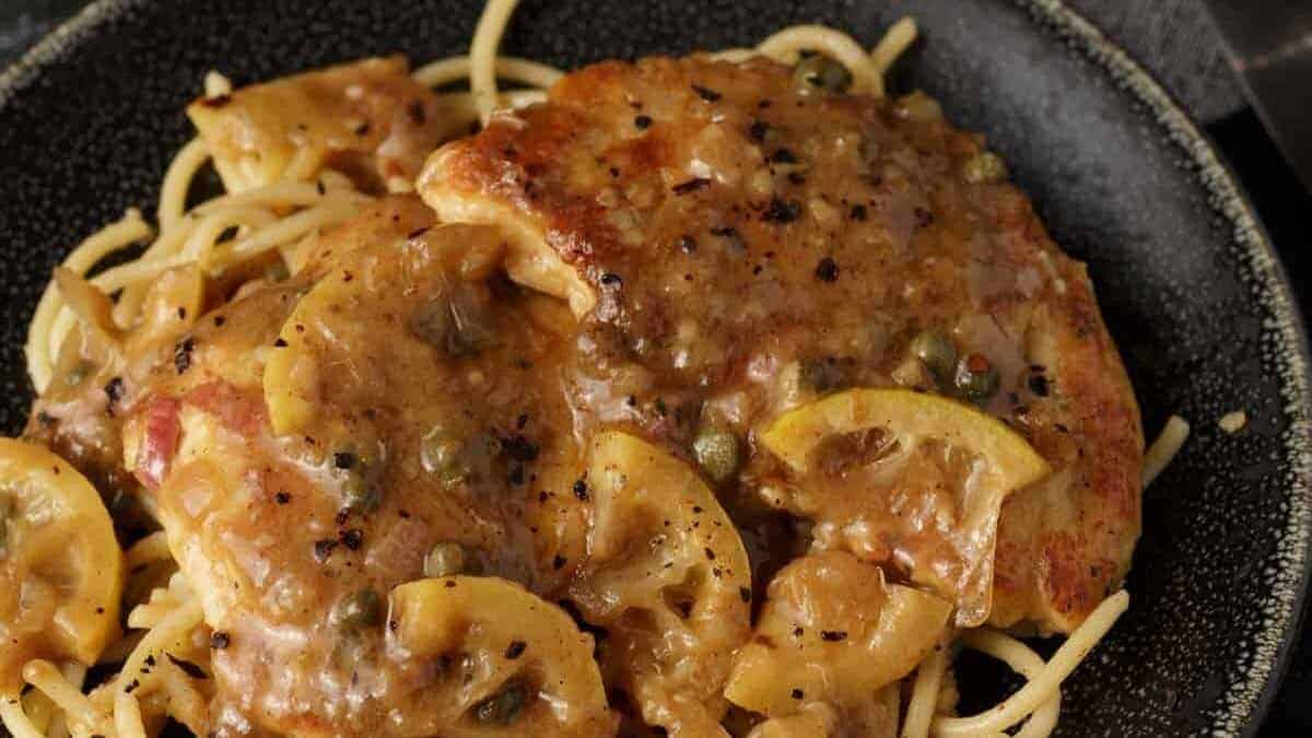 A close up shot of chicken piccata.