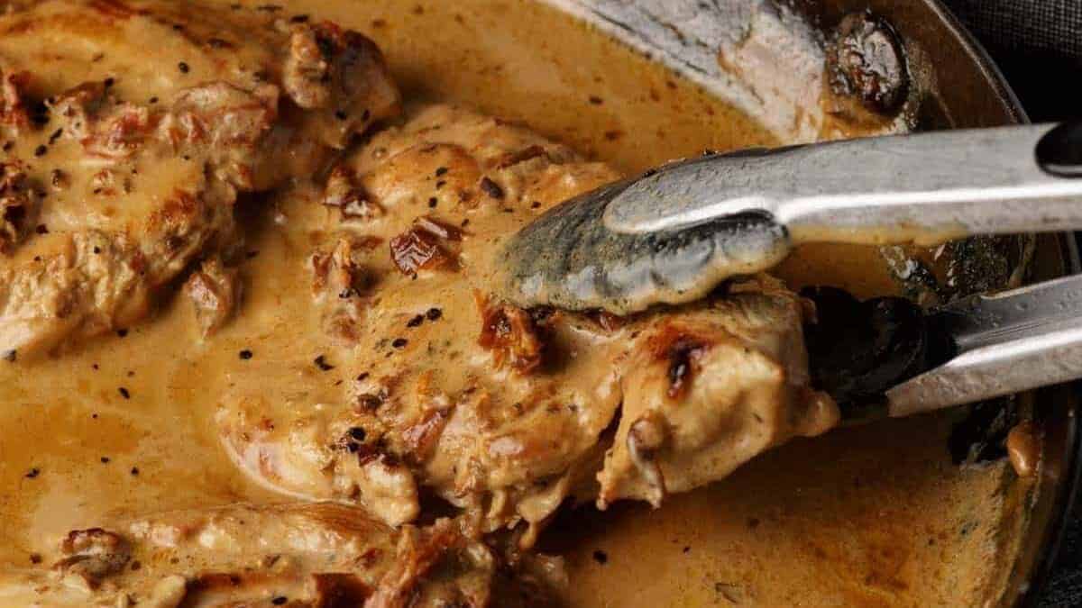 A close up shot of chicken with sundrried tomatoes.