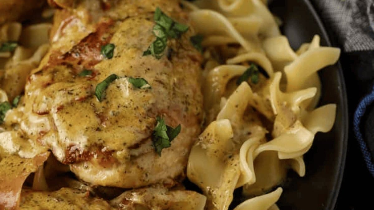 A close up shot of prosciutto wrapped chicken with pesto.