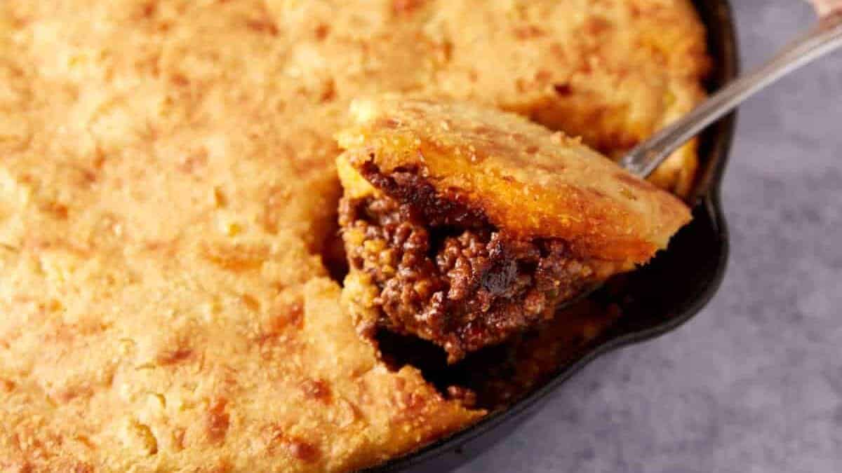 A close up shot of sloppy joes with cornbread.