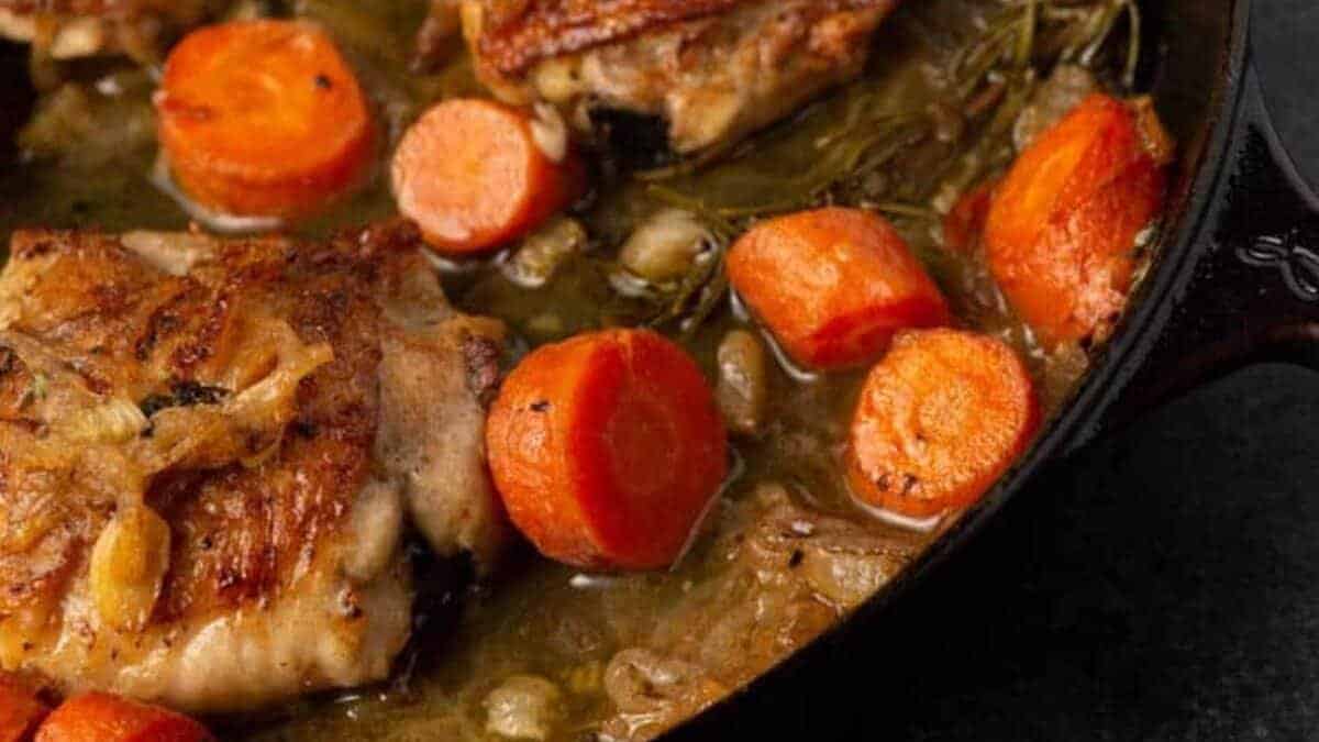 A close up shot of chicken in white wine.