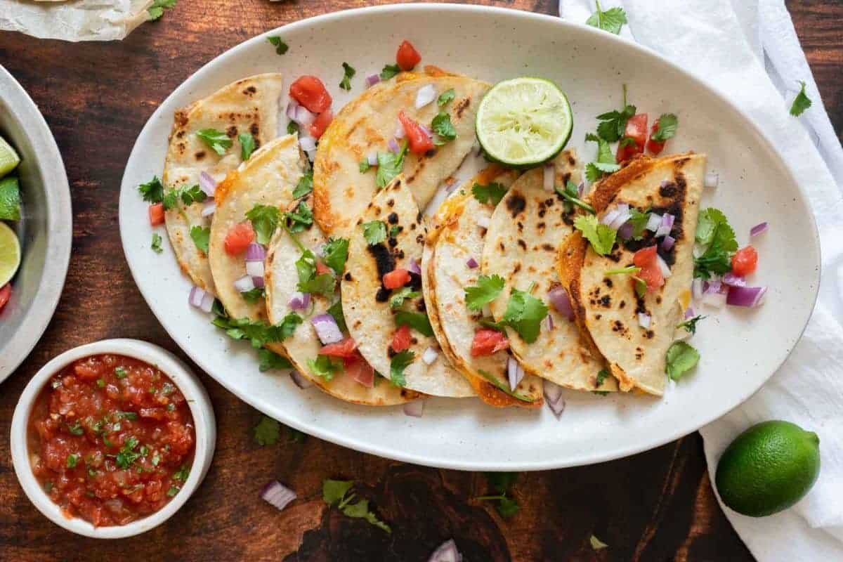 A close up shot of bean and cheese tacos.