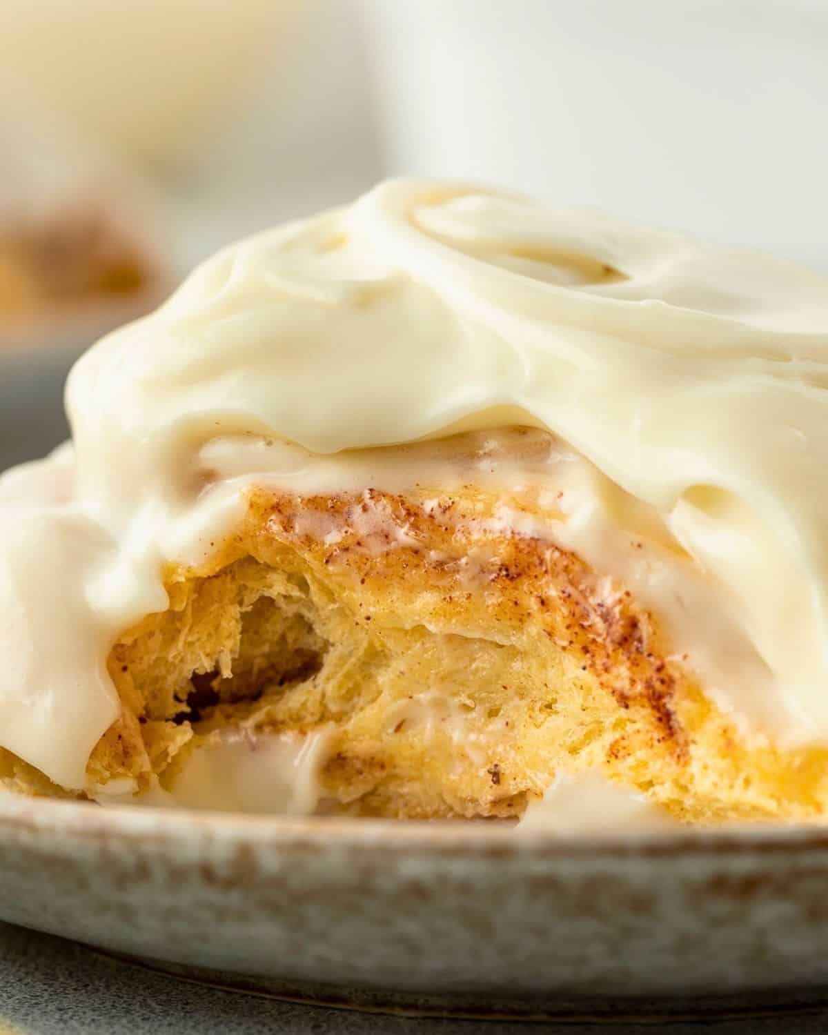 A cinnamon roll topped with thick white icing.