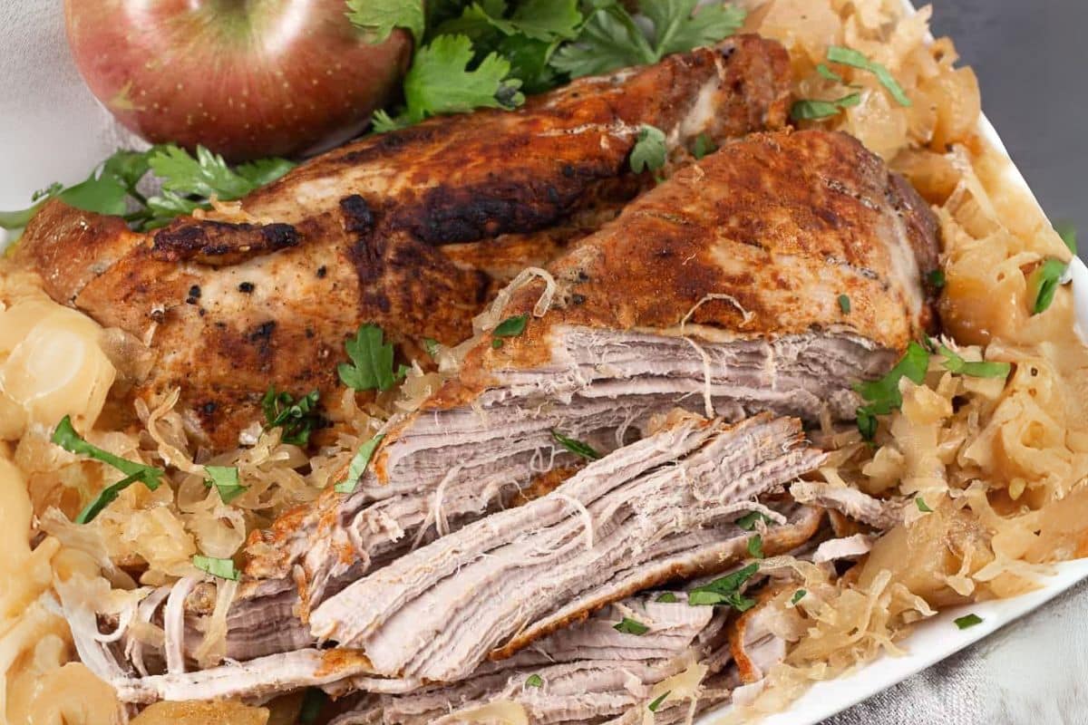 A close up shot of pork and sauerkraut.