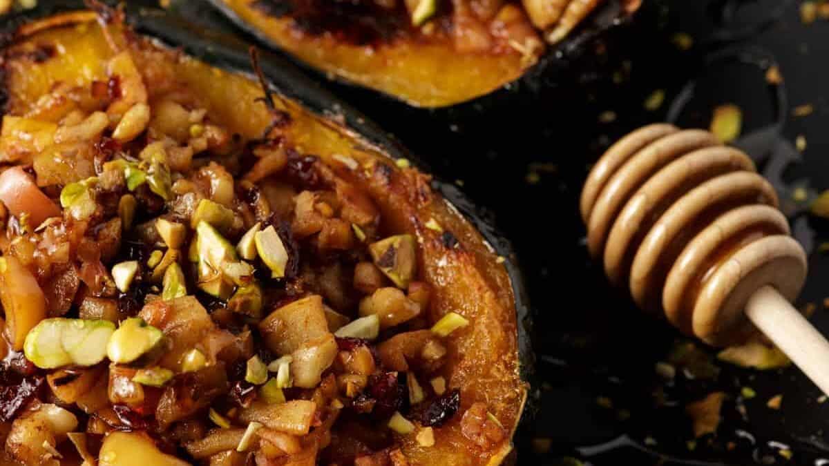 A close up shot of stuffed acorn squash with sausage and apples.