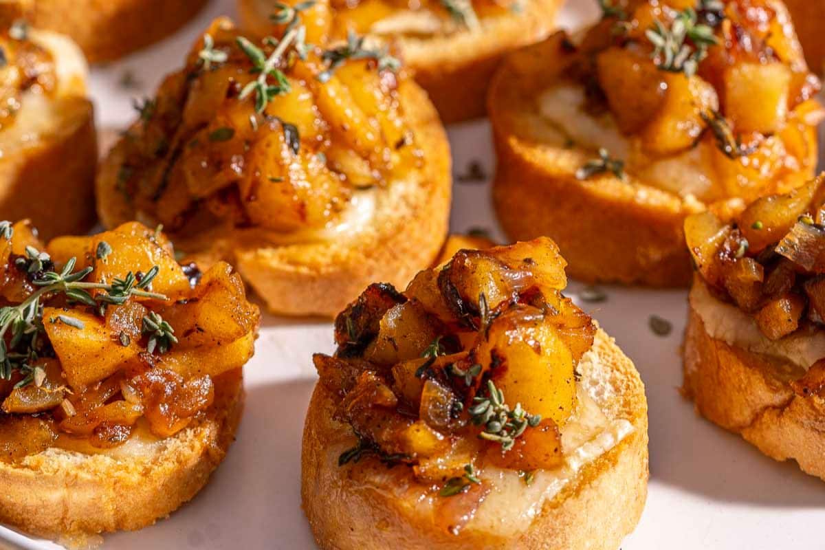 Crostini topped with caramelized fruit and fresh herbs.