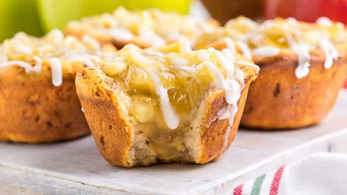 Mini apple pies with white icing glaze.