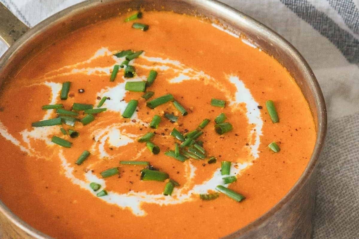 A close up shot of Red Pepper Soup with Gouda.