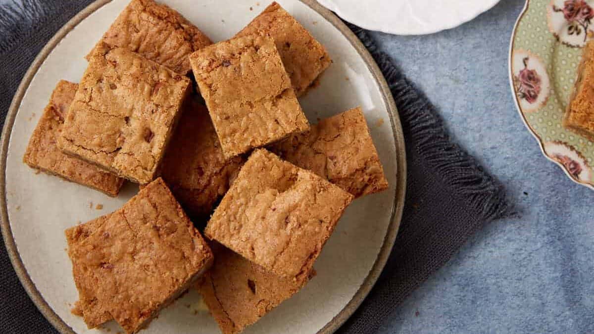 A close up shot of brown butter blondies with toffee.