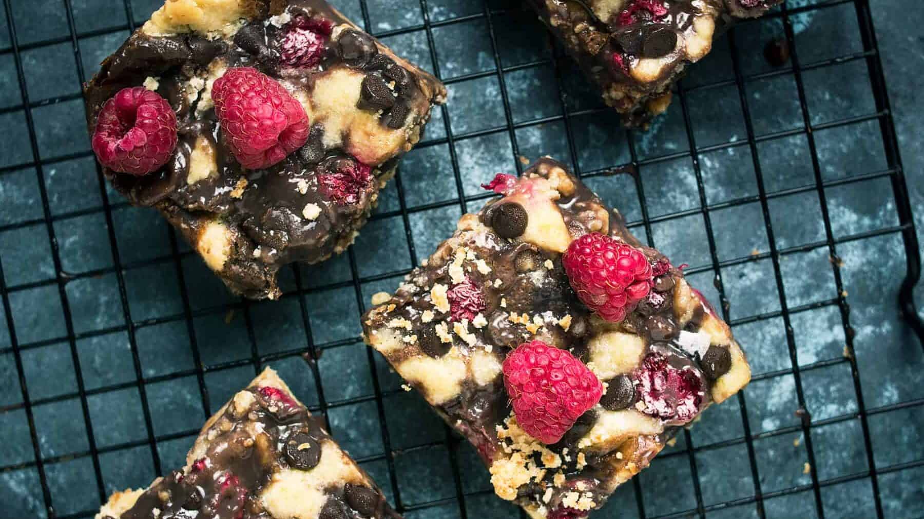 A close up shot of dark chocolate raspberry bars with shortbread crust.