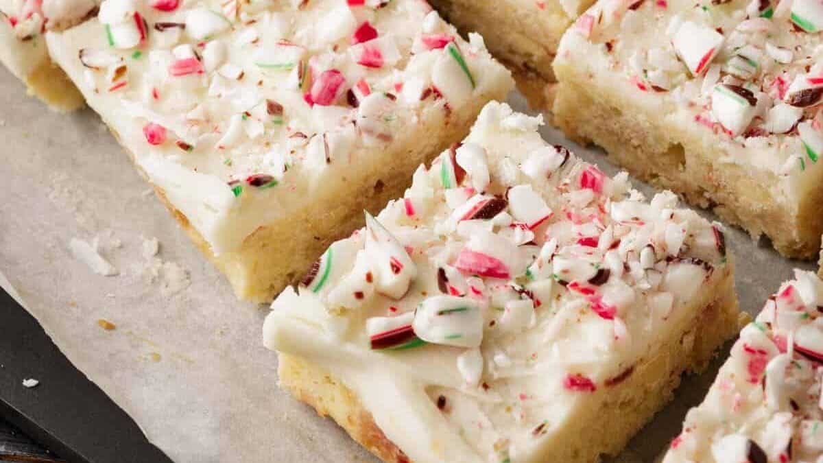 A close up shot of white chocolate blondies with peppermint frosting.