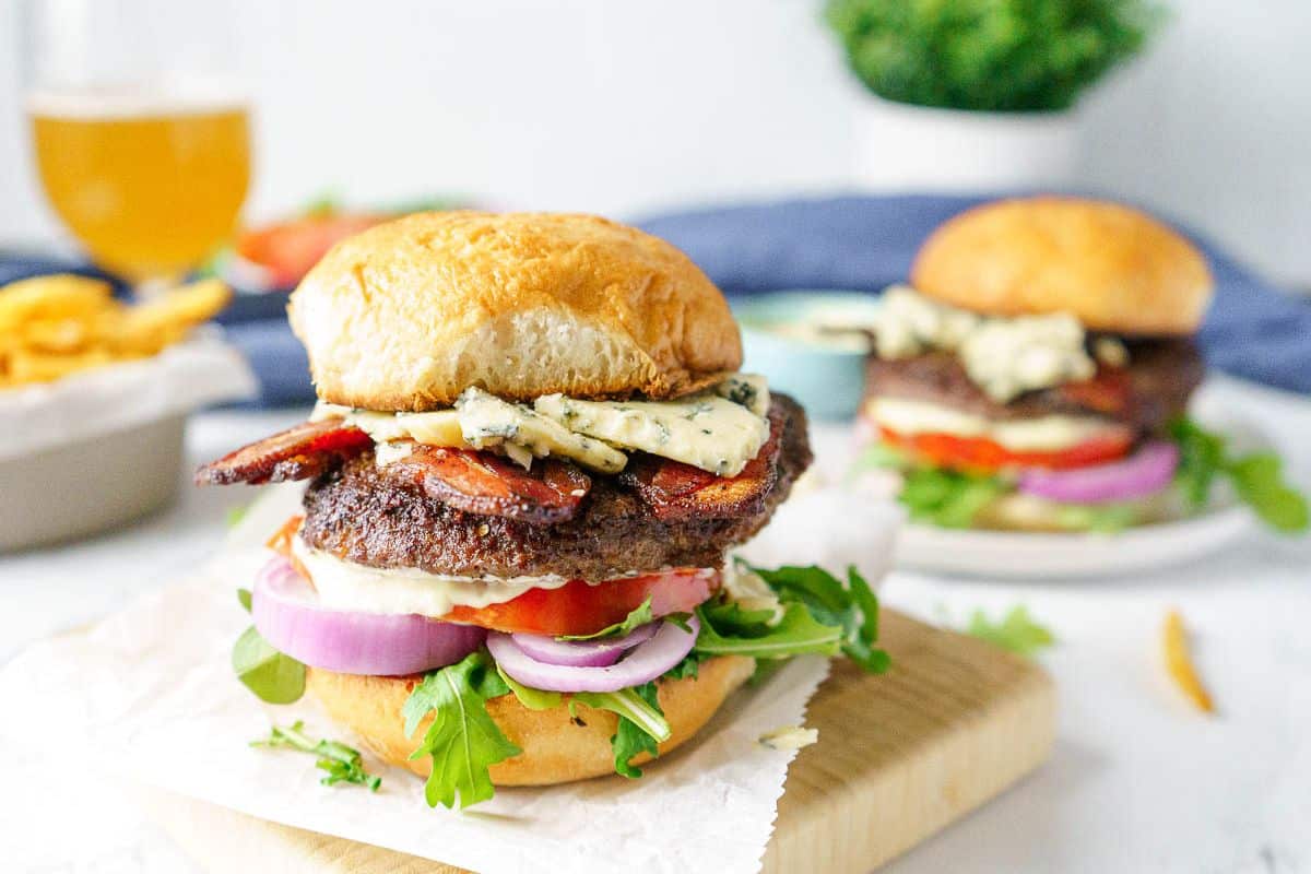 A close up shot of bacon and blue wagyu burger.