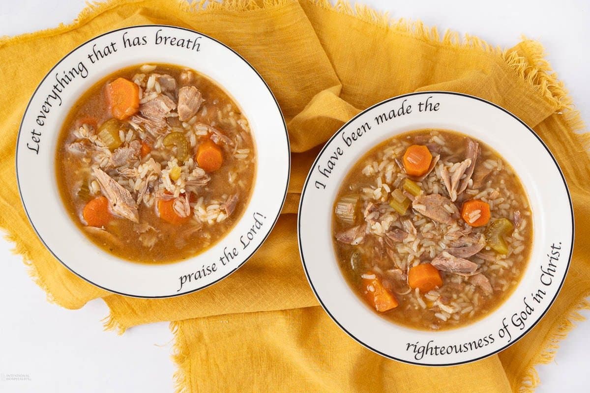 A close up shot of rice and turkey soup.